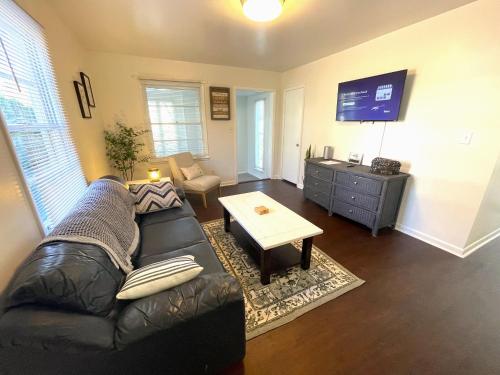 a living room with a leather couch and a table at 465 Gene Reed Rd in Birmingham