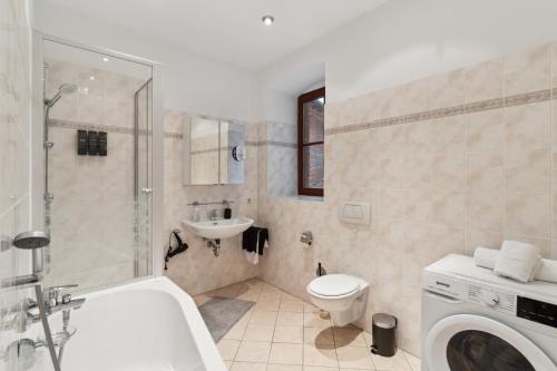 a bathroom with a sink and a toilet and a shower at KERA STAY - Apartments Merseburg in Merseburg