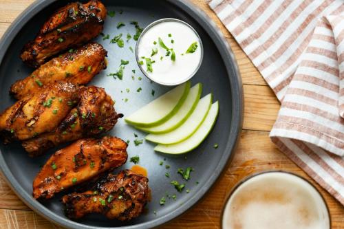 a plate of food with wings and apples on a table at Miami Marriott Biscayne Bay in Miami