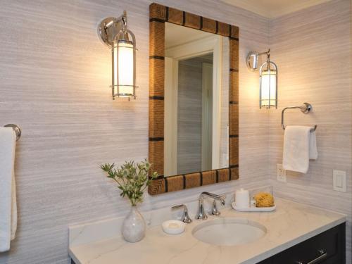 a bathroom with a sink and a mirror at Wequassett Resort and Golf Club in East Harwich