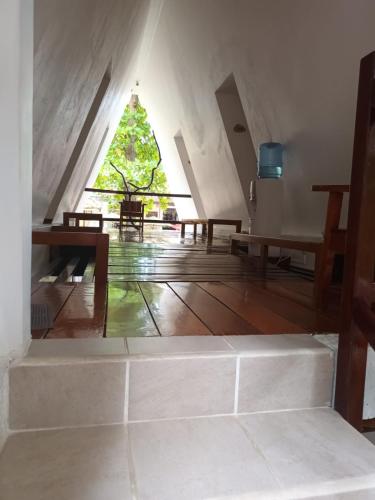 a room with tables and a christmas tree in the background at Hotel - Museo Xibalba in Palenque