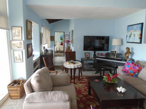 a living room with a couch and a piano at Villa Marina Porto Ixtapa in the Private Yacht Club in Ixtapa
