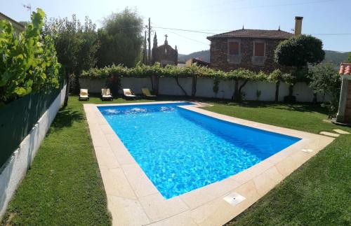 a swimming pool in the yard of a house at Casa São José in Caminha