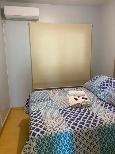 a bedroom with two beds with towels on them at Casa para 6 pessoas in Bento Gonçalves