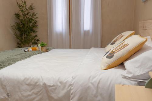 a white bed with two pillows on top of it at Casa Hoces - Alma del Cabriel in El Herrumblar