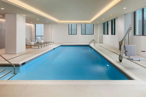 雷斯顿AC Hotel by Marriott Reston的蓝色的游泳池,位于酒店客房内