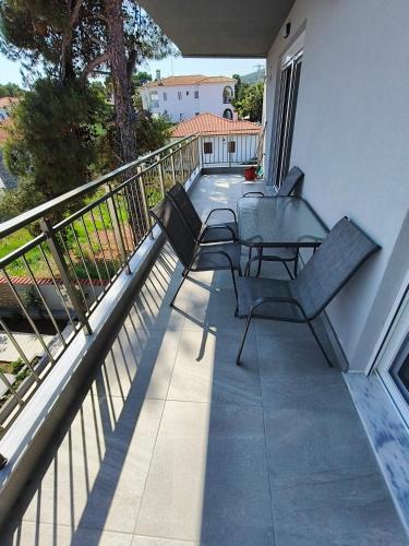 a balcony with two chairs and a table at Irina's Apartment 3 in Psakoudia
