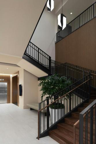 a staircase in a building with a potted plant at AC Hotel by Marriott Reston in Reston