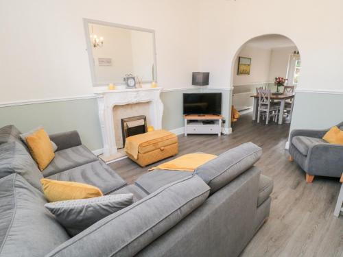 a living room with a couch and a fireplace at Roseberry House in Guisborough