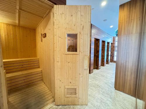 an empty sauna with a wooden wall in a building at Malibu Langkawi Private Pool Villa in Pantai Cenang