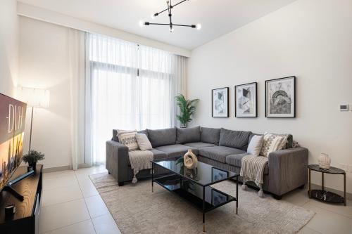 a living room with a couch and a table at Burj Crown Luxury 4 Bedroom, Balcony Views, 5 min to Burj Khalifa in Dubai