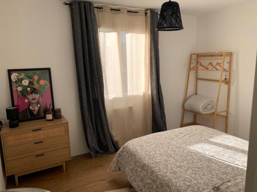 une chambre avec un lit et une commode avec une fenêtre dans l'établissement Villa Serena - 3 chambres grand confort - 6 personnes, à Carpentras