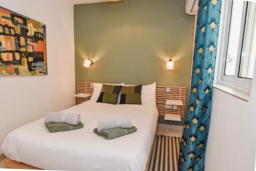 a bedroom with two beds and a window at Ramla Valley Vista in Nadur with Private Pool in Nadur