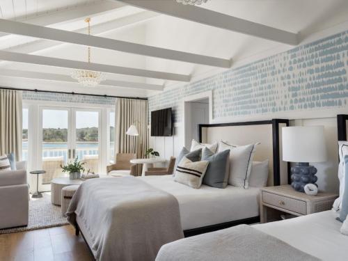 a bedroom with two beds and a blue wall at Wequassett Resort and Golf Club in East Harwich