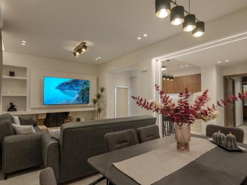 a living room with a couch and a table at Ergina Apartments Gournes Studio & Family Apartment in Gournes