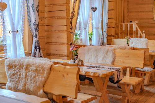 a living room with a couch and a table at Apartamenty Monika SPA i Agroturystyka in Korbielów