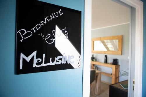 a door with a sign that says welcome to a living room at Le repaire de Mélusine - Gîte de charme et love room in Sainte-Marie-Cappel