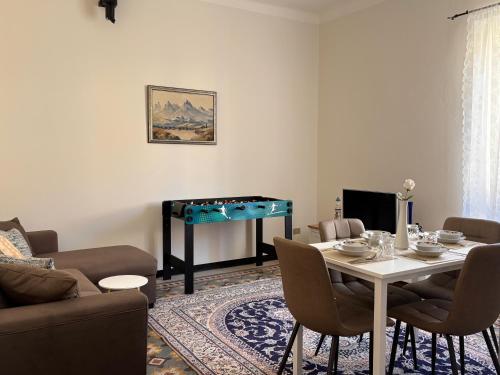 a living room with a table and a pool table at Trilocale a 100 m dal mare in Imperia