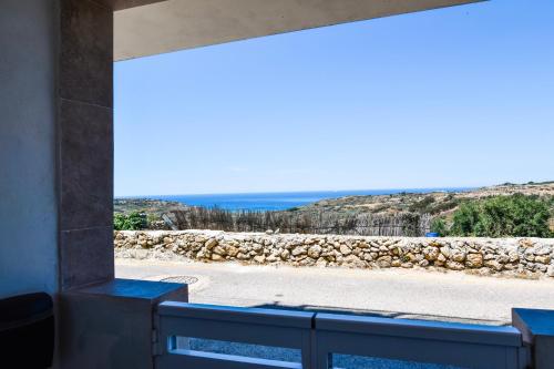 a view from a window of a stone wall at Ramla Valley Vista in Nadur with Private Pool in Nadur