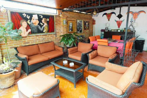 a living room filled with furniture and a brick wall at Enjoy AC in the Queen's Suite at Inn Ajijic in Ajijic
