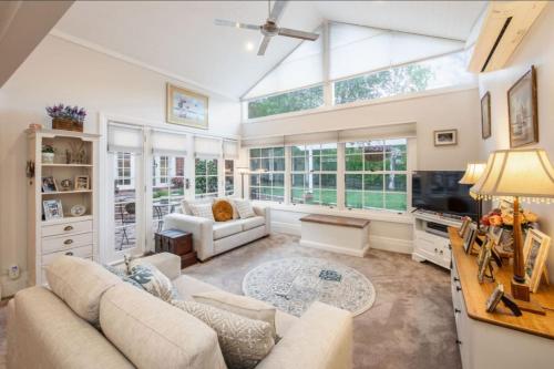 a living room with a couch and a table at Botanical gardens retreat in Albury