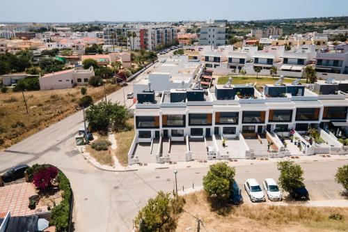 an aerial view of a building with a parking lot at Spacious house in Olhao in Quelfes