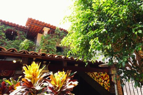 a building with a fence and some plants at Enjoy AC in the Queen's Suite at Inn Ajijic in Ajijic