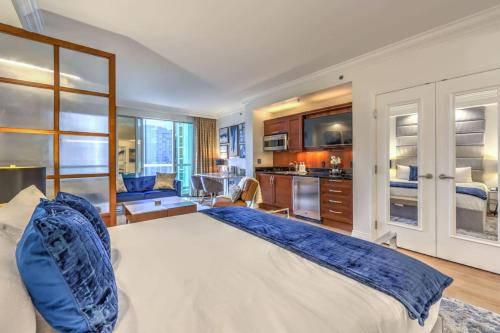 a bedroom with a large bed and a kitchen at MGM Grand Vegas Strip 16th Floor Renovated Suite in Las Vegas