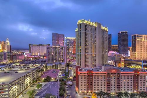 a city skyline at night with many tall buildings at MGM Grand Vegas Strip 16th Floor Renovated Suite in Las Vegas
