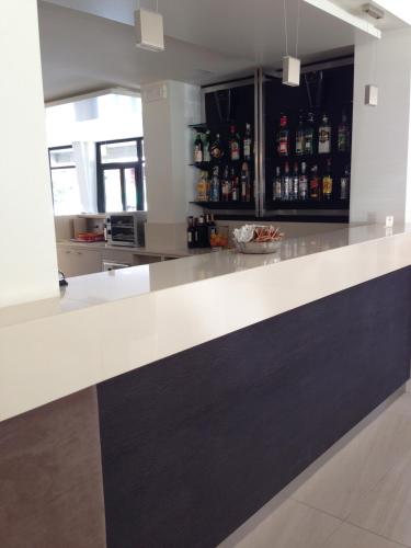a kitchen with a white and black counter top at Hotel Holiday in Sirmione