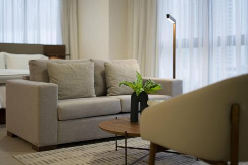 a living room with a couch and a table at Deluxe Loft with City View in Panama City