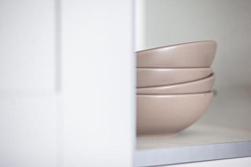 a white bowl sitting on a shelf next to a window at The Cedar - Free Parking, Netflix, Near M1, M69 in Enderby