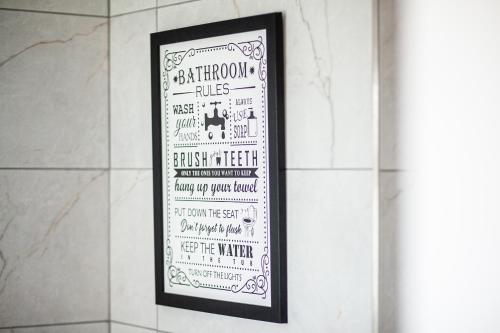 a framed poster on a wall in a bathroom at The Cedar - Free Parking, Netflix, Near M1, M69 in Enderby
