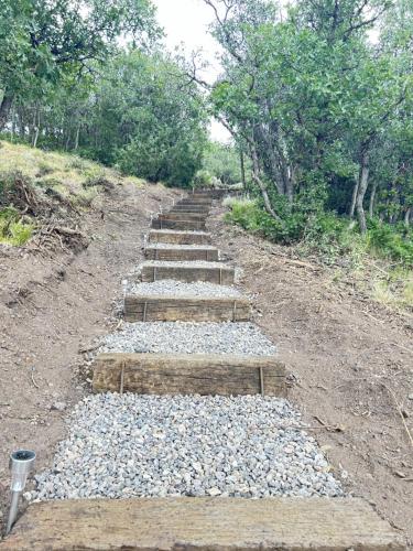 a set of stone steps on a dirt road at Woodland Cabins by Jerny Destinations in Alton