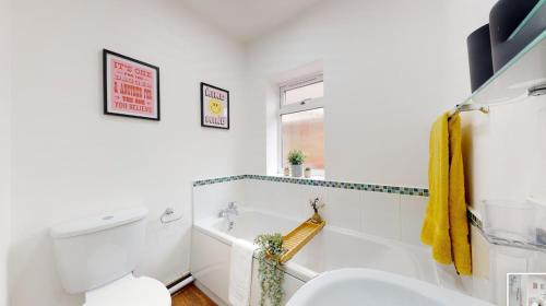 a white bathroom with a toilet and a sink at Central & Modern - Fast WIFI - 5 Min to Centre in Cardiff