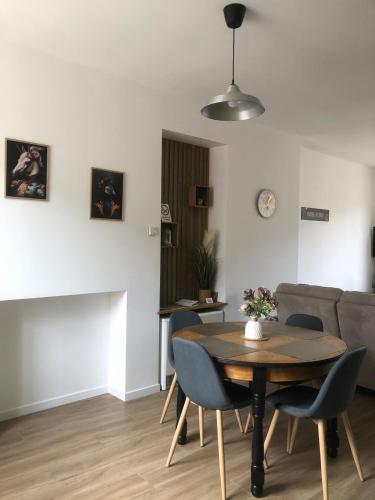 un salon avec une table, des chaises et un canapé dans l'établissement Chez Sindy et Olivier, à Crèvecoeur-le-Grand