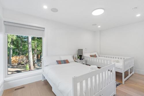 una camera da letto bianca con un letto e una finestra di 2505 Edgemont Blvd.- Anupoju a North Vancouver