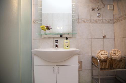 y baño con lavabo blanco y espejo. en Antonija Apartments with Pool, en Biograd na Moru