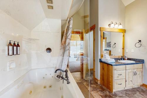 ein Badezimmer mit Badewanne und Waschbecken in der Unterkunft Timberland in Garden City