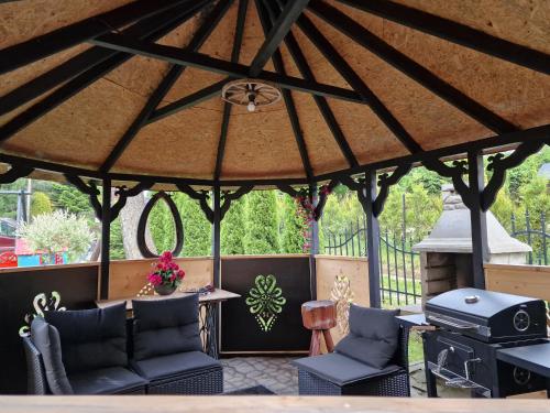 a large gazebo with chairs and a grill at Pokoje Gościnne U Moniki i Daniela in Zakopane