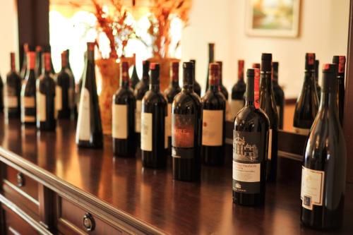 a bunch of bottles of wine sitting on a table at Hotel Vila e Arte City Center in Tirana