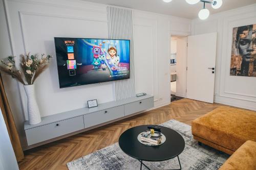 a living room with a flat screen tv on a wall at Centru Est One in Drobeta-Turnu Severin