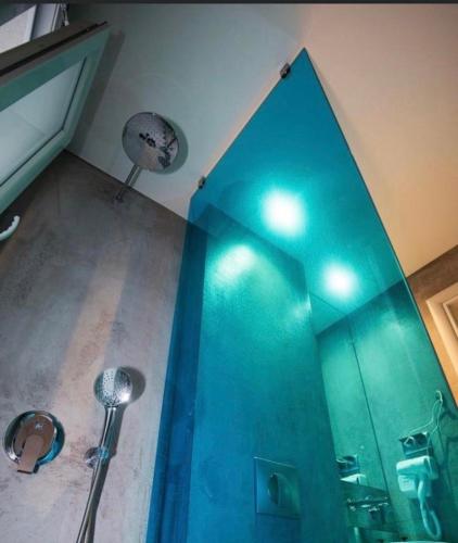 a shower in a bathroom with a blue shower at Katrine Boutique Apartments in Kavála