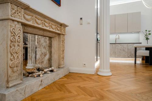 a fireplace in a living room with a wooden floor at Riverside N22 in Prague