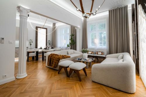 a living room with white furniture and a table at Riverside N22 in Prague