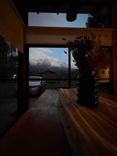 a table with a view of a snow covered mountain at Rest in the mountains in El Bolsón