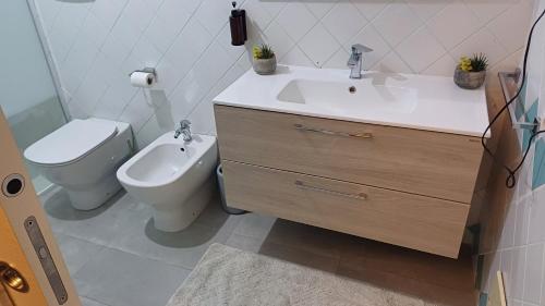 a bathroom with a sink and a toilet at Luxury Suite Quartu in Quartu SantʼElena