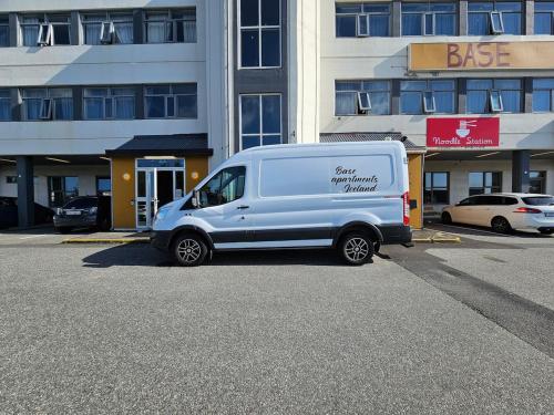 a blue van parked in front of a building at Base apartments ap 204 - Capital region of Reykjavík in Hafnarfjördur