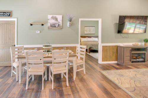 a dining room with a table and chairs and a bedroom at 15 Mi to Pigeon River Rafting Newly Built Cabin! in Newport