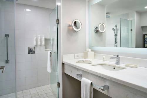 a bathroom with a sink and a shower at Marriott Puebla Hotel Meson del Angel in Puebla